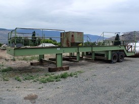 Low Boy Trailer. 10 ft. wide x 40 ft. long. 16 in. x 5 1/2 in. I-beam. Tandem Axle. Light and brake connectors. Walkways and hand rails.